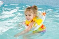 Four-year girl floating in the pool