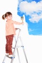 Four-year girl stand on a ladder and draws a pictu Royalty Free Stock Photo
