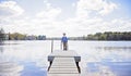 Boy on dock looking in lake Royalty Free Stock Photo