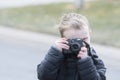 Four Year Old Toddler Boy Taking Photos Outside with a Camera Royalty Free Stock Photo