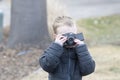 Four Year Old Toddler Boy Taking Photos Outside with a Camera Royalty Free Stock Photo