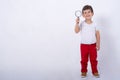 Four years boy looking through a magnifying glass, preschool kids, education. Isolated on white background, modern learning kids.