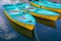 Four yellow and blue boats in a still lake water Royalty Free Stock Photo