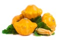 Four yellow pattypan squash with leaf and flower isolated on white background Royalty Free Stock Photo