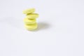 Four yellow tablets are stacked on top of each other. White background