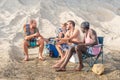 four young adults having fun on the beach Royalty Free Stock Photo