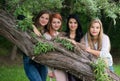 Four young beautiful ladies posing in the park