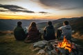 Four young campers gathered around a crackling campfire