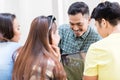 Four young employees sharing opinions and information in the office