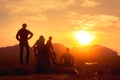 Four friends relax on sea and sunrise viewpoint