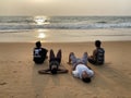 Four young Indian men relaxing on a beach in Goa