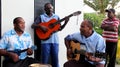 Four young men playing island music for guests visiting Fiji,2016