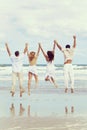 Four Young People Two Couples Jumping in Celebration On Beach Royalty Free Stock Photo