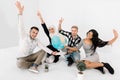 Four young smiling multiethnical people, international students, holding Earth globe, hands up, looking at camera. Focus Royalty Free Stock Photo