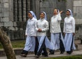 Four young Vietnamese nuns in Ao Dai going to church service.