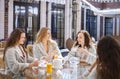 Four young women drinking tea at spa resort Royalty Free Stock Photo