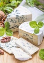 Fourme d`ambert blue cheese  and walnuts. Wooden background. Top view Royalty Free Stock Photo