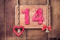 Fourteen valentine vintage card, heart hanging on wooden wall background