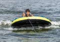 Fourteen year-old Amerasian boy tubing on Grand Lake in Oklahoma.