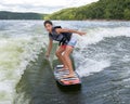 Fourteen year-old Amerasian boy wake surfing on Grand Lake in Oklahoma.