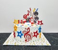 Fourteenth birthday cake for music teen. Playing the guitar and violin