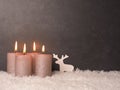 Fourth Advent candle burns, dark stone background Royalty Free Stock Photo