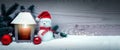 Fourth Advent. Christmas lantern and snowman with santa claus hat on white snow. Royalty Free Stock Photo