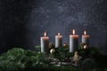 Fourth advent with four burning candles on fir branches with Christmas decoration against a dark grey background, copy space Royalty Free Stock Photo