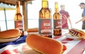 Holiday composition with multiple bottles of beer and hot dogs, American flag. Group of people celebrating Independence day of USA Royalty Free Stock Photo