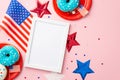 Fourth of July concept. Top view photo of photo frame national flag stars plates with donuts and confetti on isolated pastel pink