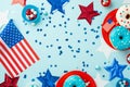 Fourth of July concept. Top view photo of national flags stars confetti paper backing molds with candies and plates with glazed