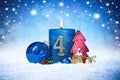 Fourth sunday of advent blue candle with golden metal number red decoration one on wooden planks in snow front of silver panorama