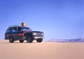 Fourwheeldrive in the desert driving by woman Royalty Free Stock Photo