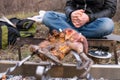 Fowl preparing, Hunting theme. Cooking a whole Pheasant body on an iron skewers over a campfire with burning coals and