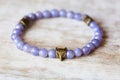 metal brass pendant beed on violet angelite mineral stone bracelet Royalty Free Stock Photo