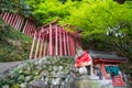 Fox statue at red wood gate of Yutoku Inari Shrine, Kashima