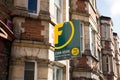 Foxtons Estate agent sign outside a row of Victorian terraced houses