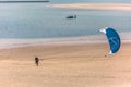 View of a male professional Kiteboarder walking on the sand beach, at the Obidos lagoon Royalty Free Stock Photo