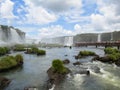 Foz do IguaÃÂ§u, Brazil, view of the misty Iguassu Falls, with tourists on the footbridge over the waters.