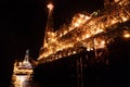 FPSO tanker vessel near Oil platform Rig at night. Offshore oil and gas industry Royalty Free Stock Photo