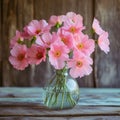 Fragile beauty Pink flowers in a glass vase on wood