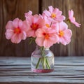 Fragile beauty Pink flowers in a glass vase on wood