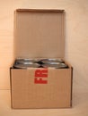 Fragile cardboard box with tin cans Royalty Free Stock Photo