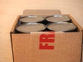 Fragile cardboard box with tin cans Royalty Free Stock Photo