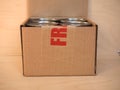 Fragile cardboard box with tin cans Royalty Free Stock Photo