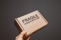 Fragile handle with care cardboard box in male hand isolated Royalty Free Stock Photo