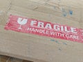 Fragile tape sign on a cardboard shipping box