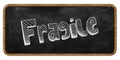 FRAGILE written in chalk on blackboard. Wood frame.