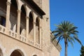 Fragment of the Almudaina Palace against the background of palm trees and blue sky. Palma de Mallorca. Majorca. Spain Royalty Free Stock Photo