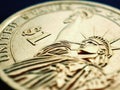 Fragment of American 1 dollar coin closeup. Statue of Liberty and the sign of national currency. US economy and money. News about
